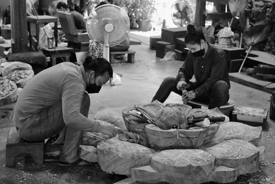 Craftsman dressing a stone surface in a fabrication workshop