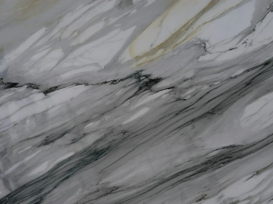 Grey-veined white marble slab surface